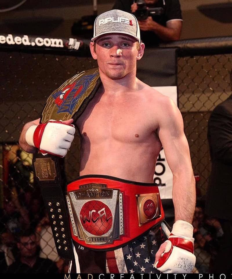 Jake Spray Champion with Belts
